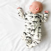 Milk Dino cotton sleepsuit